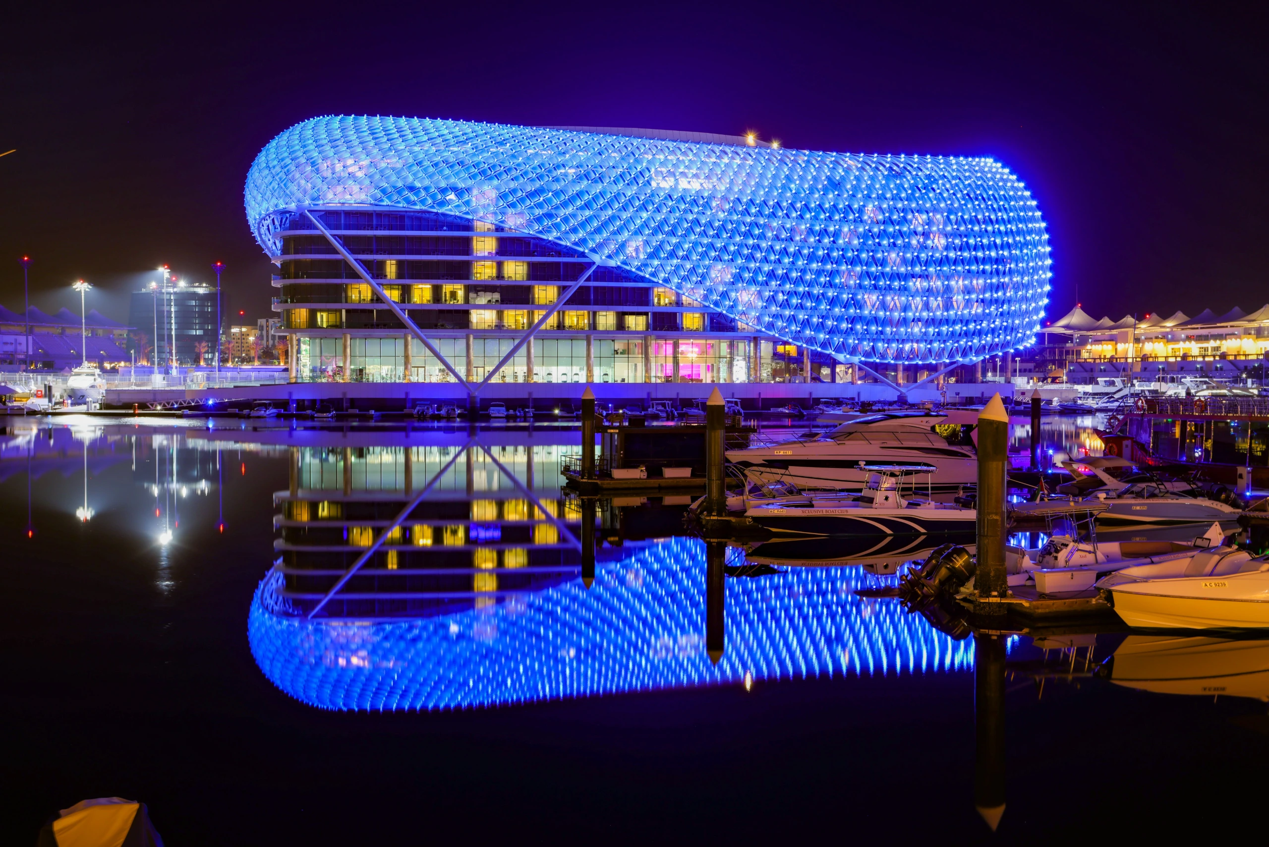 W Abu Dhabi Yas Island at night with blue light facade reflecting in marina